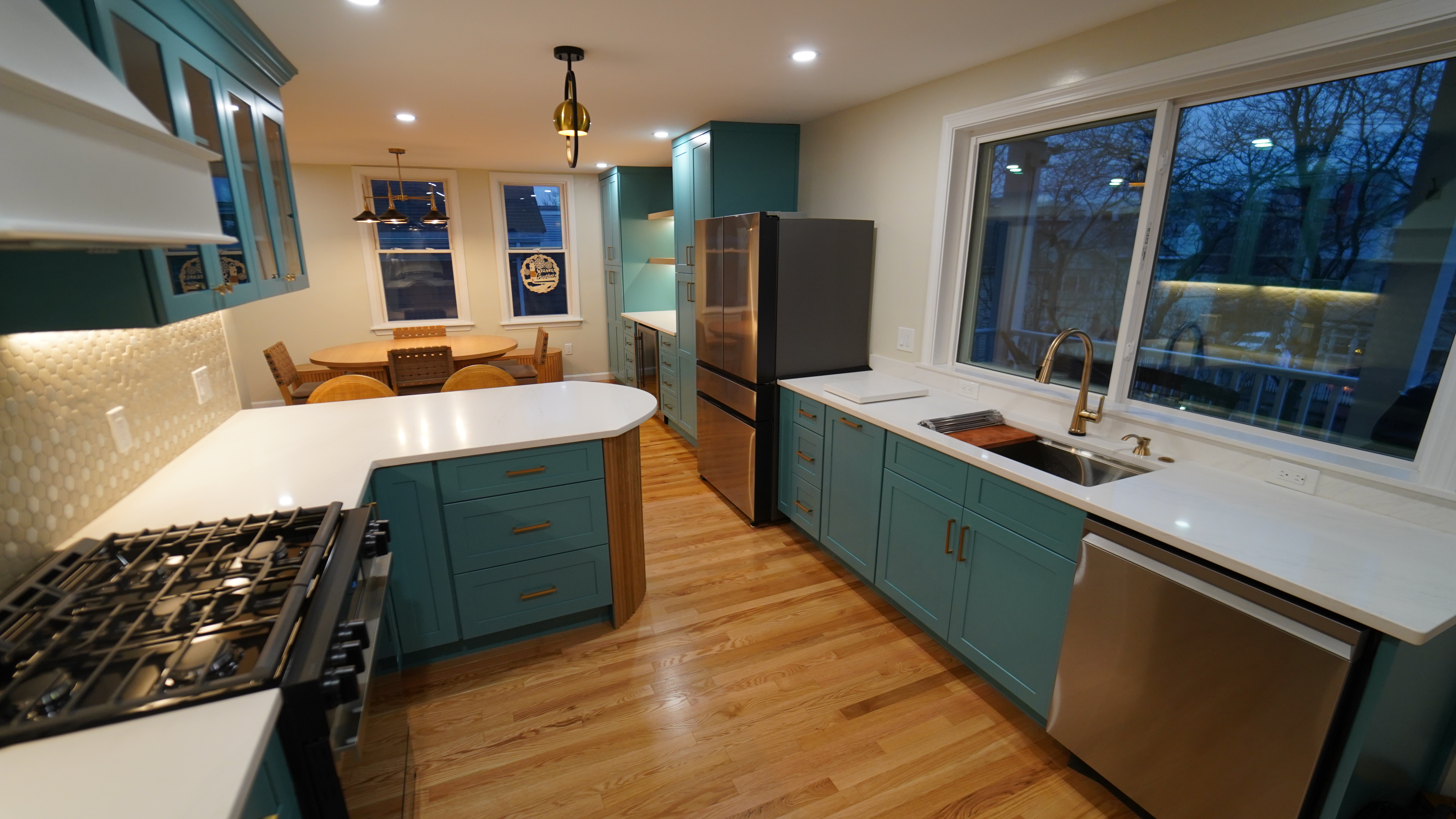 Chelsea kitchen sink, counter, and blue lower cabinetry