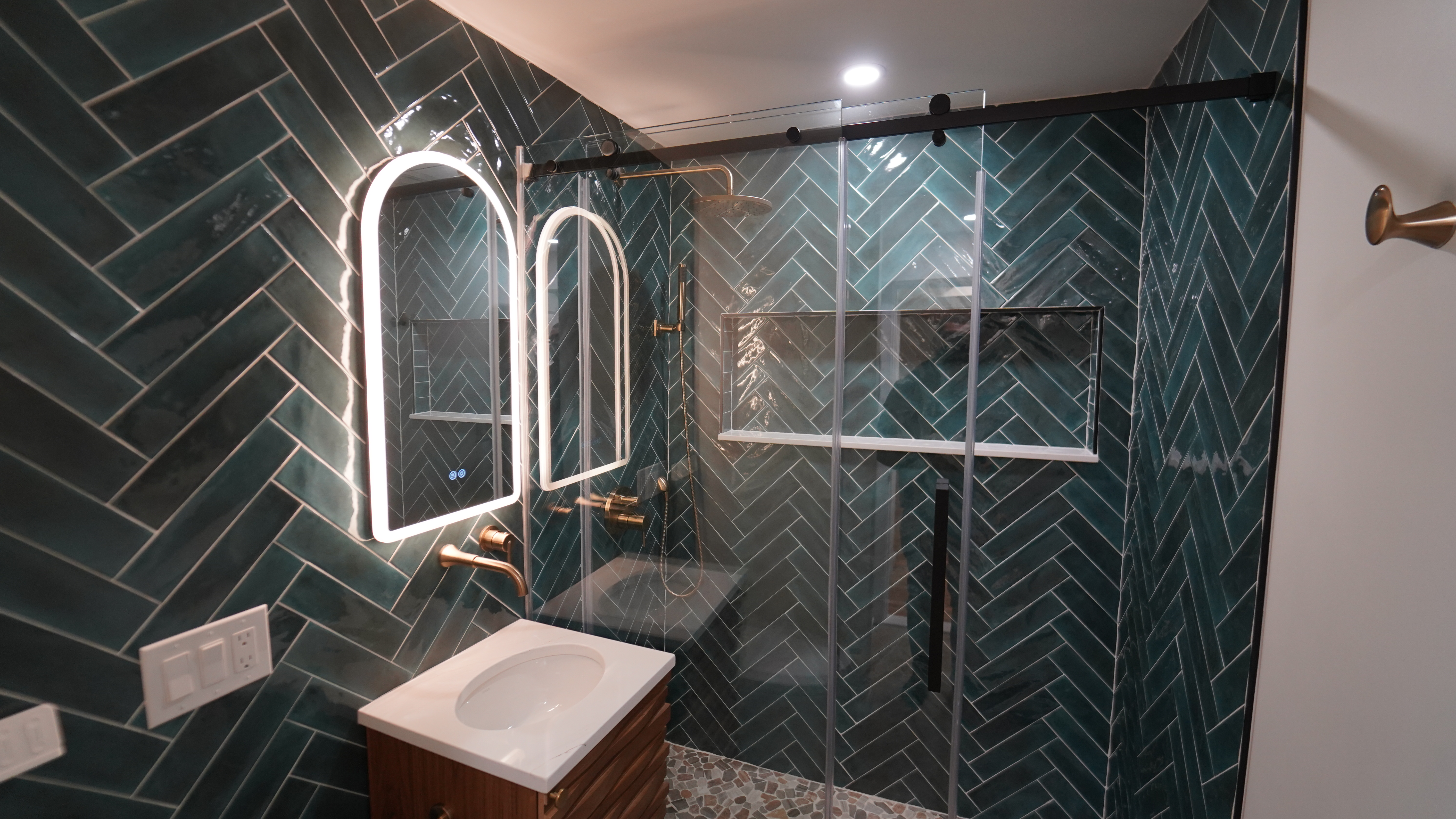 Chelsea bathroom with dark tile, modern vanity, and glass shower
