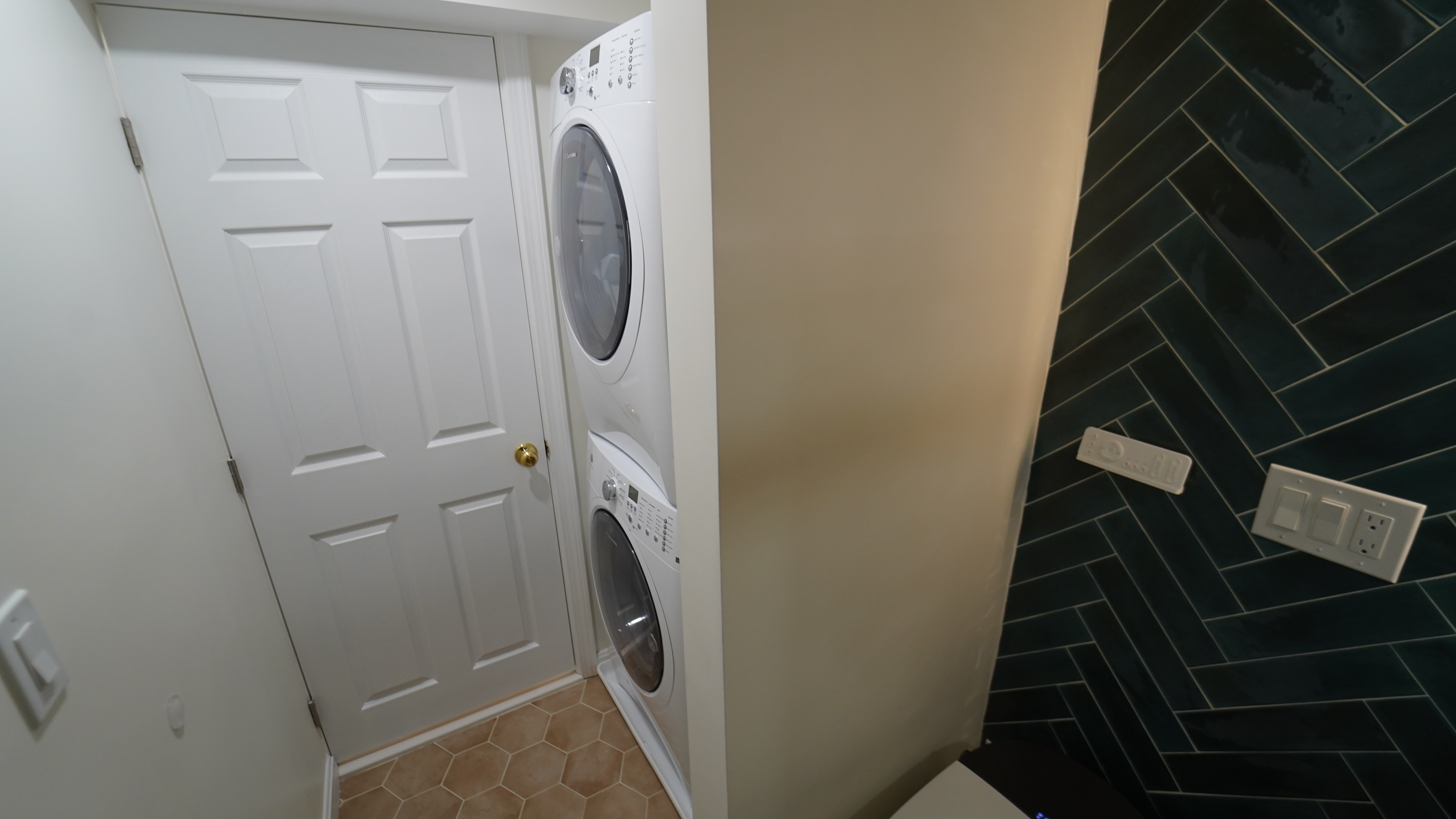 Chelsea laundry area with stacked washer and dryer