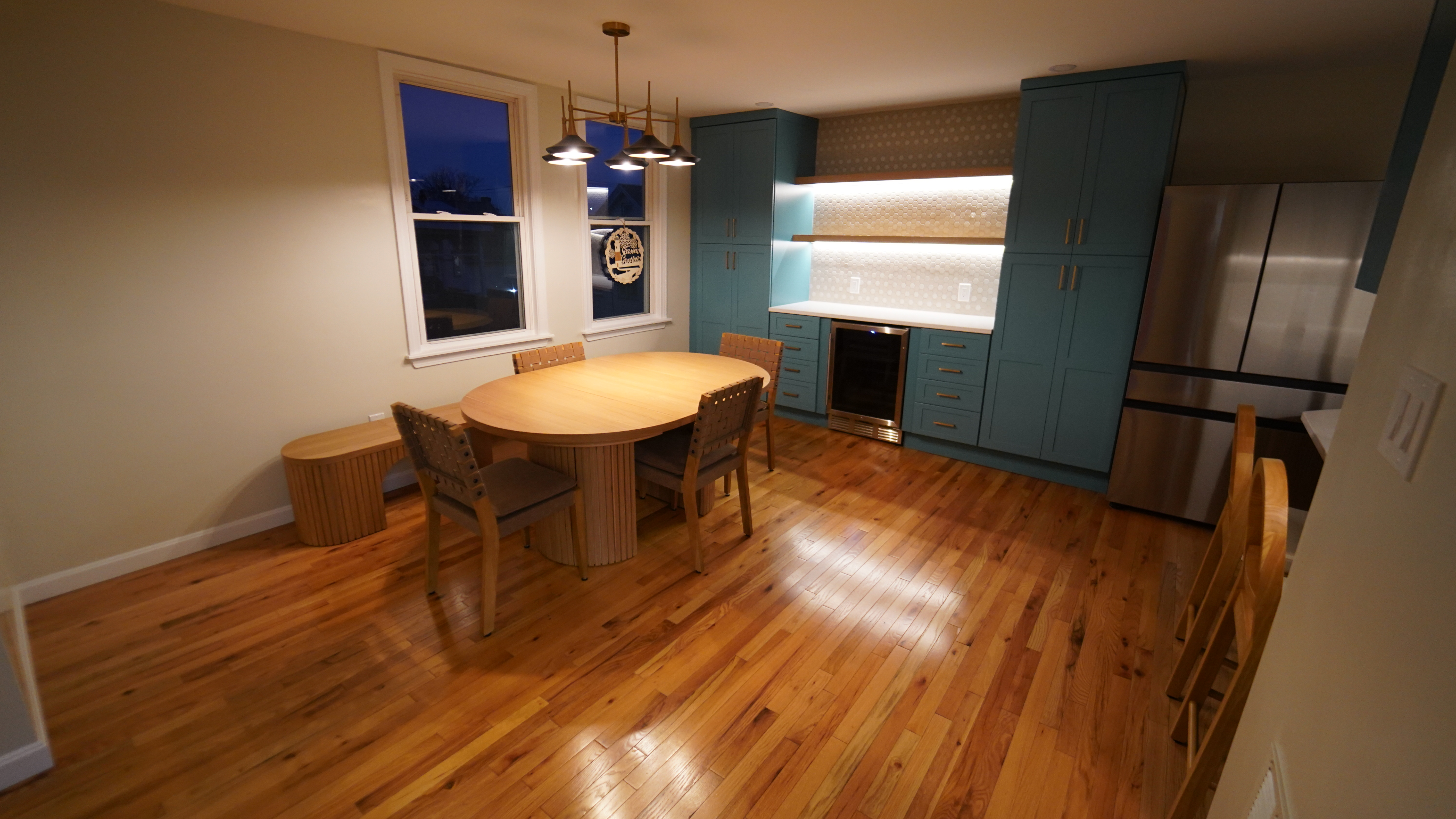 Chelsea dining area with built-in cabinetry and warm lighting